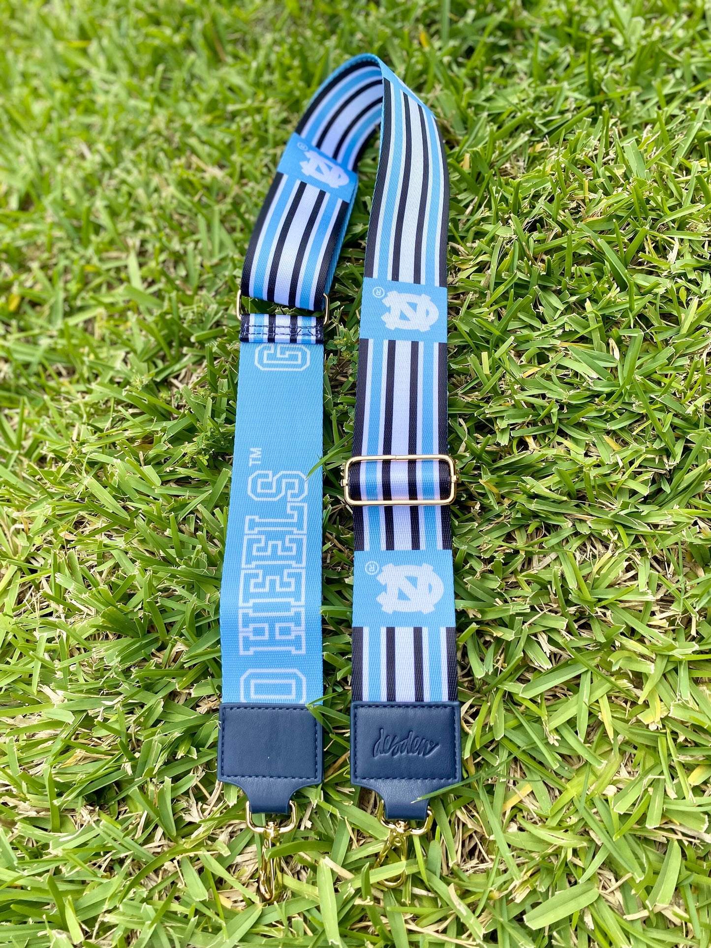 North Carolina purse strap featuring a blue and white design, adjustable for crossbody or shoulder wear.
